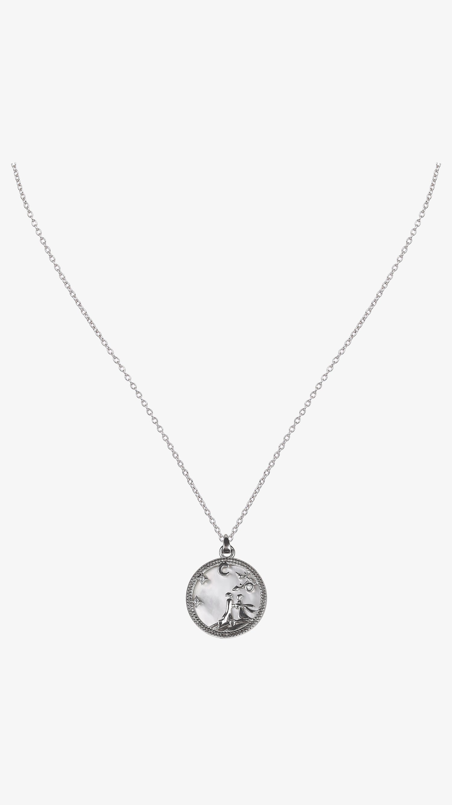 Silver necklace with a round pendant on a white background