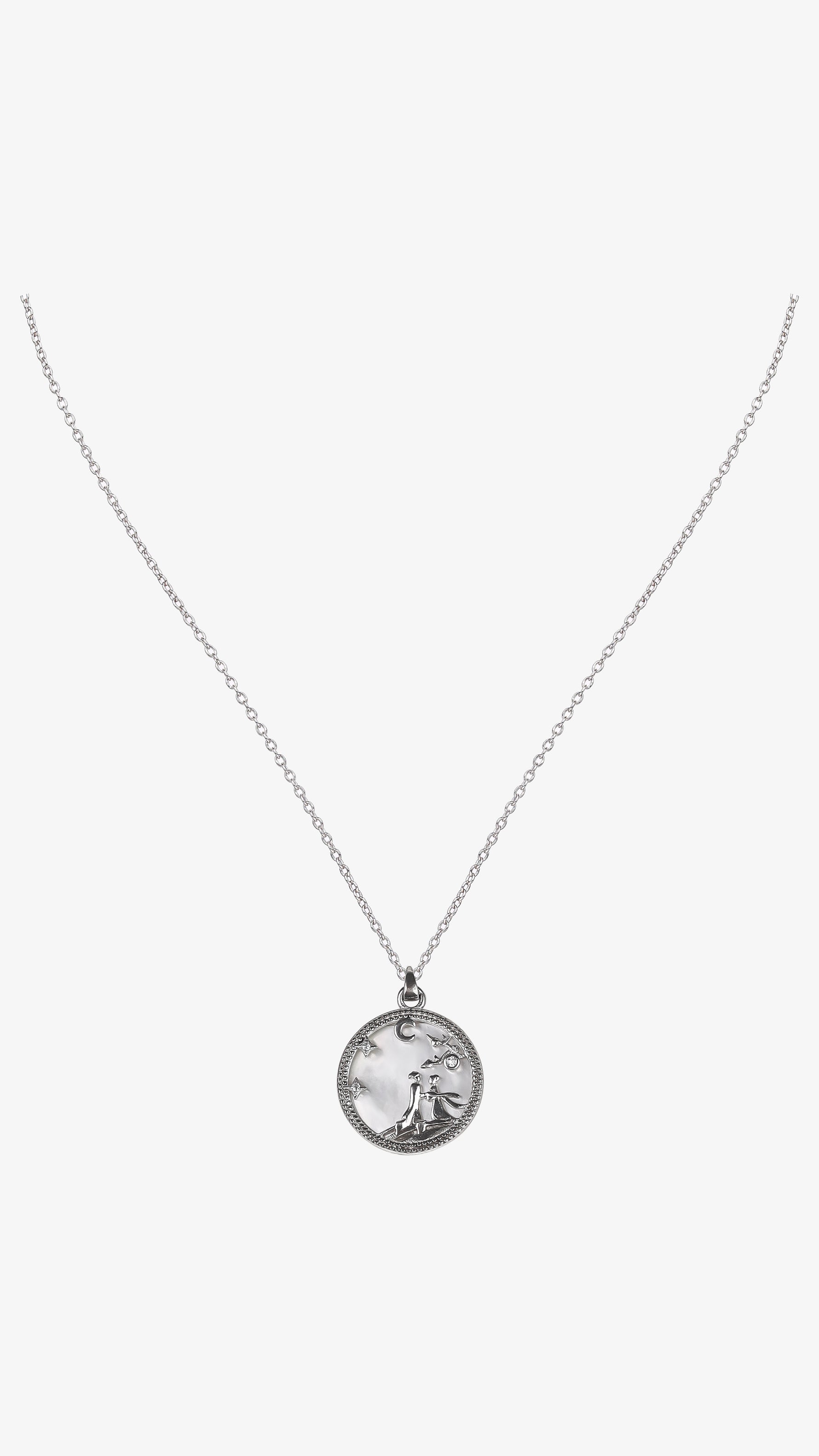 Silver necklace with a round pendant on a white background